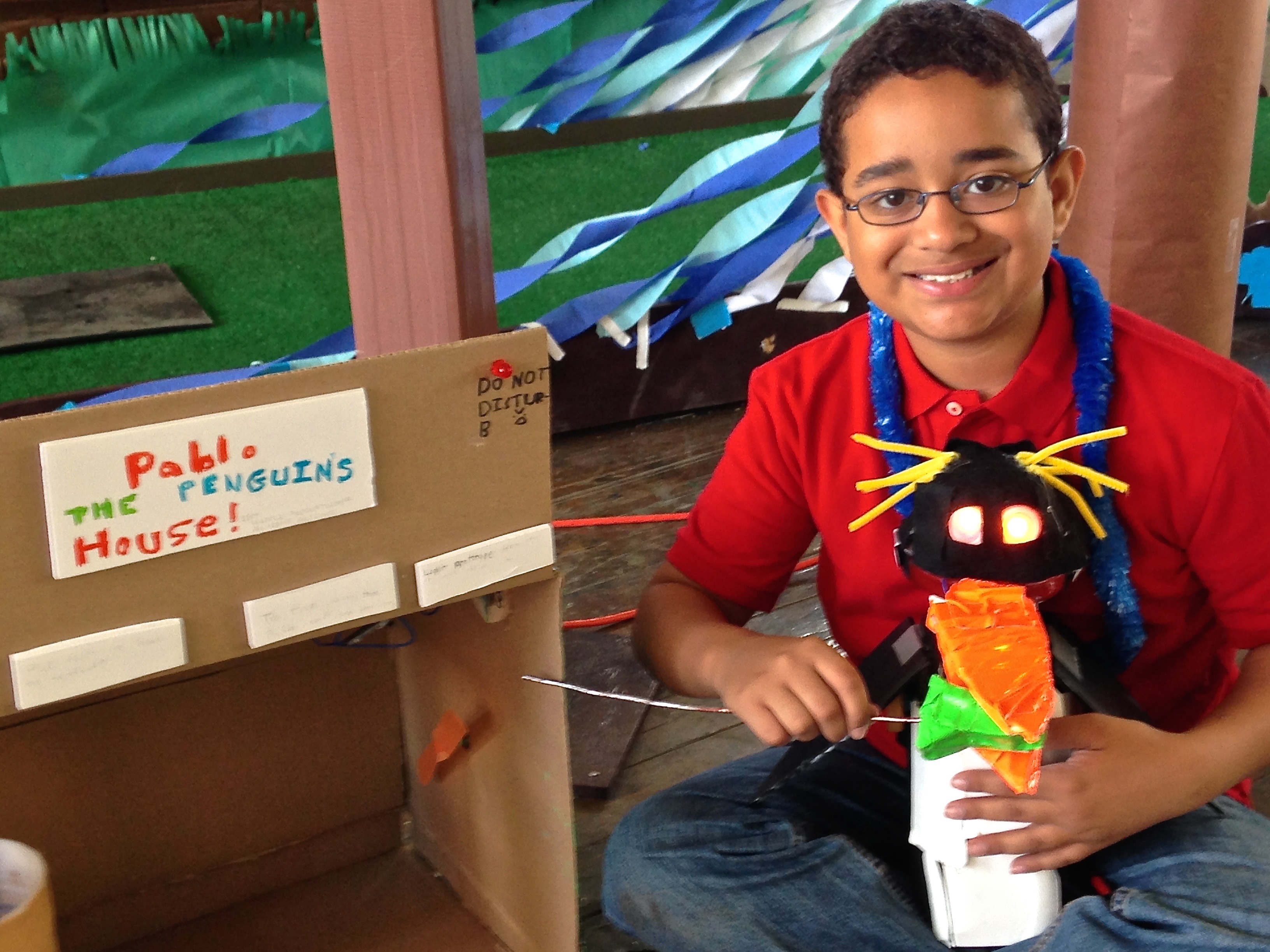 photo of boy with electromechanical penguin